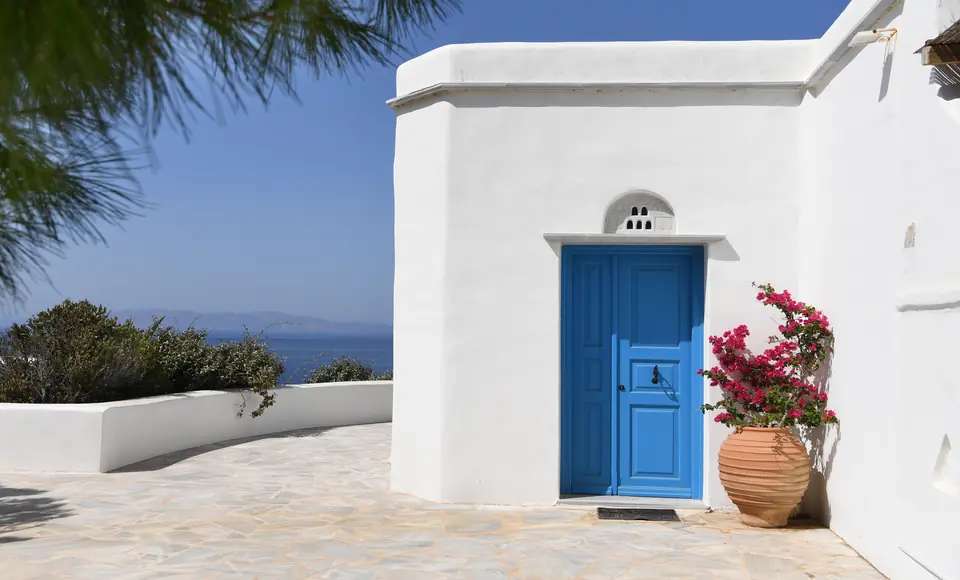 Blue Cycladic door with bougainvillea at Villa Akrivi